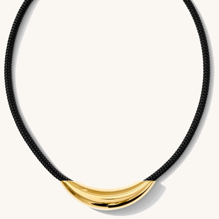 Close up of the gold Monroe bar necklace on a paracord chain on a white background