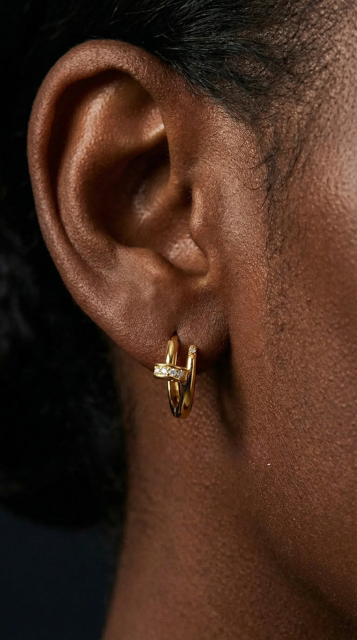 The Nailed It huggie earrings in 14k gold vermeil, shaped like a curved nail