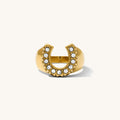 Close up of the gold Nashville horseshoe ring on a white background