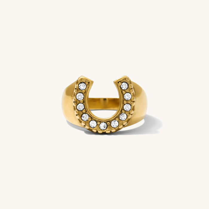 Close up of the gold Nashville horseshoe ring on a white background