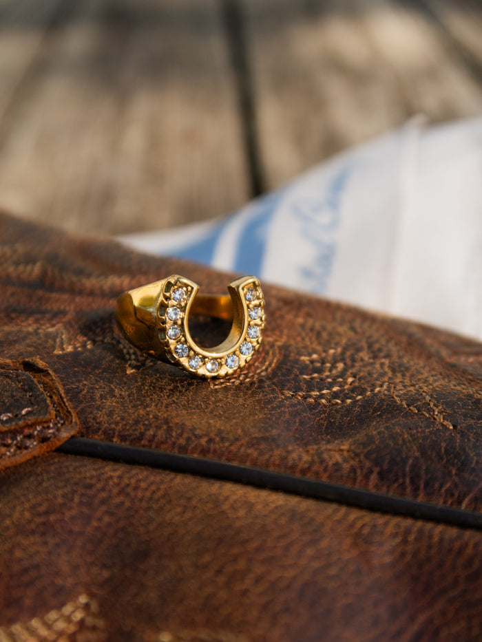 Nashville ring with a sculptural gold horseshoe lined with light-catching stones
