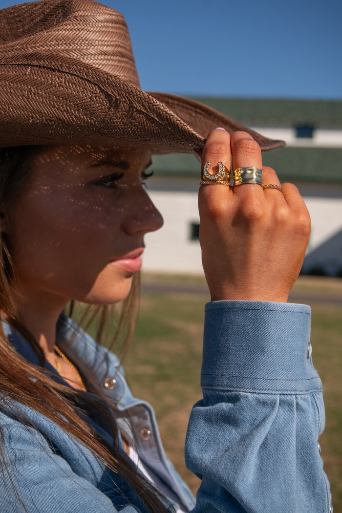 Gold Nashville horseshoe ring with sparkling stones set along the silhouette
