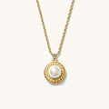 Close up of the gold La Mer pearl pendant necklace on a white background