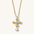 Close up of the gold Jordan cross pendant necklace on a white background