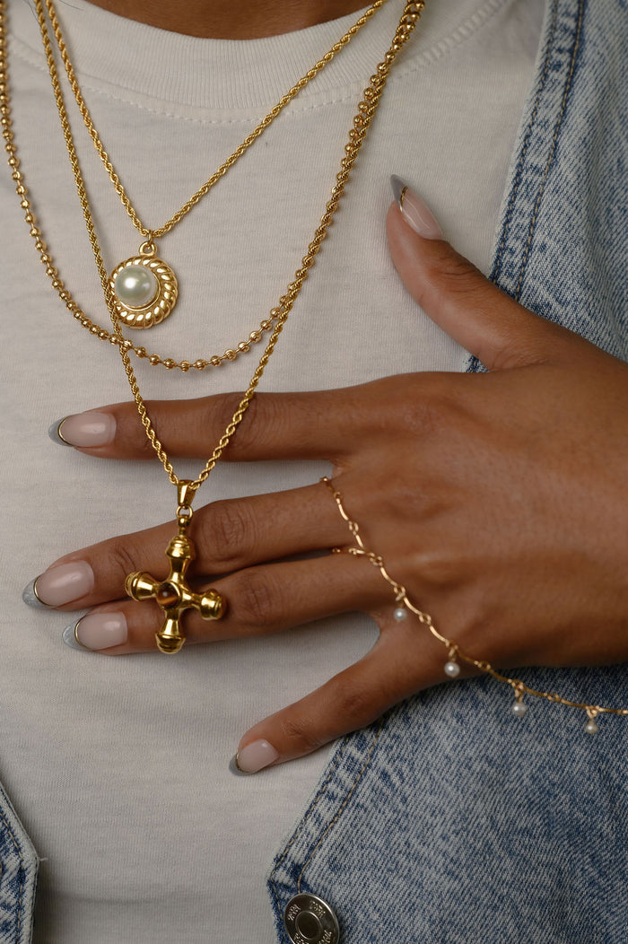 The gold La Mer pearl pendant necklace from Beads by Tara, shown on a white background