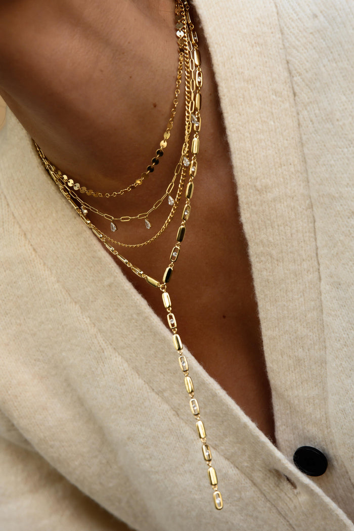 Gold Nellie lariat necklace with a long sparkling cubic zirconia drop