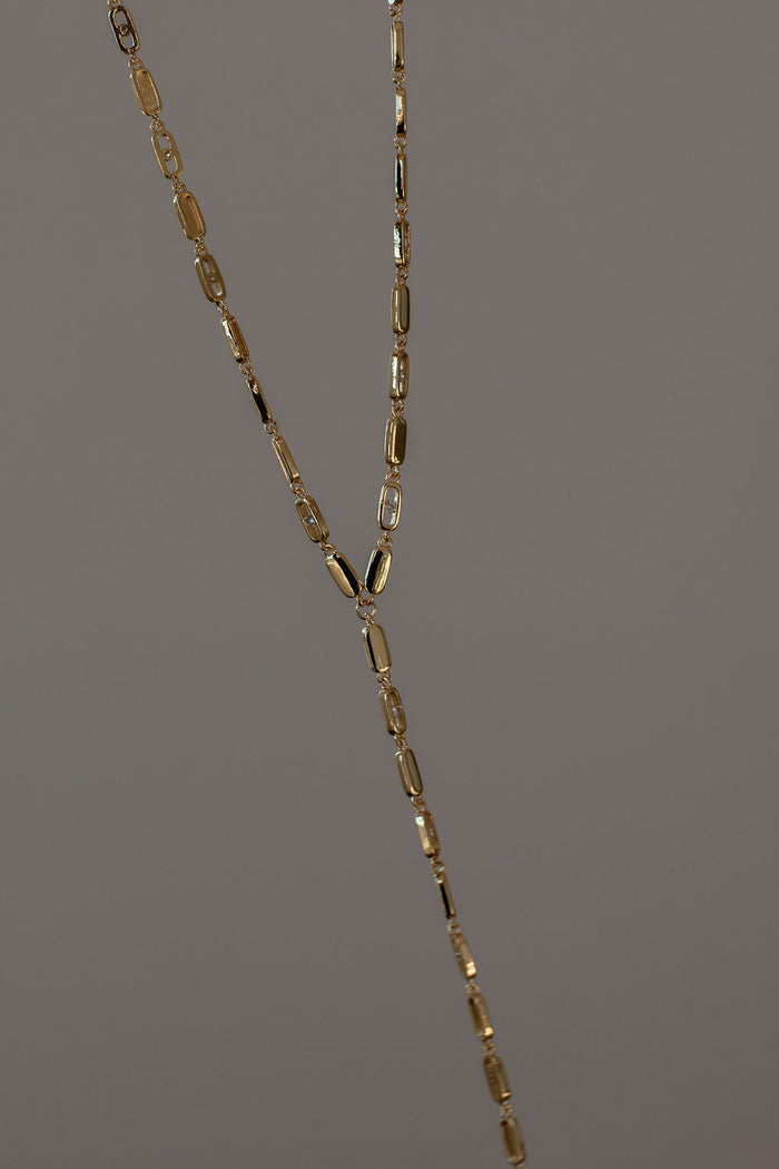 Nellie lariat necklace in 14k gold plate with a dramatic crystal drop