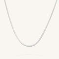 Close up of the silver Nile herringbone chain necklace on a white background