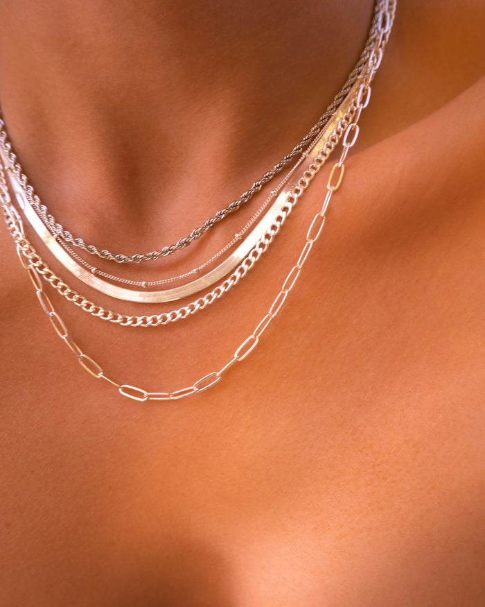 Close up of a neckline wearing the silver Nile herringbone necklace