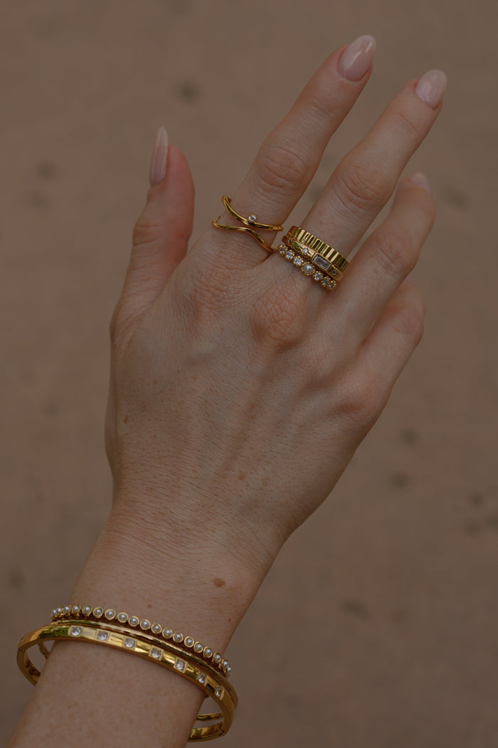 Studio close up of the gold North Star ring on a white background