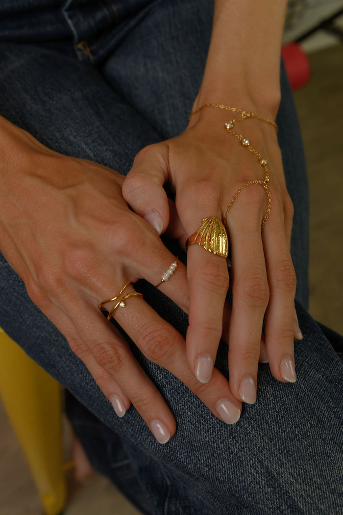 Close up of the gold North Star ring by Beads by Tara on a white background