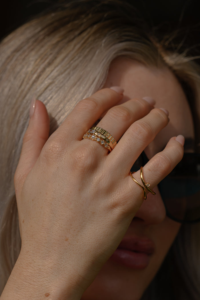 Close view of the gold North Star ring on a white background