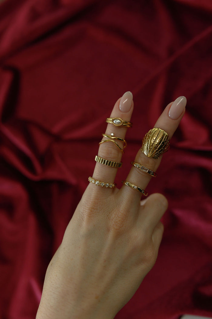A closer look at the gold North Star ring on a white background