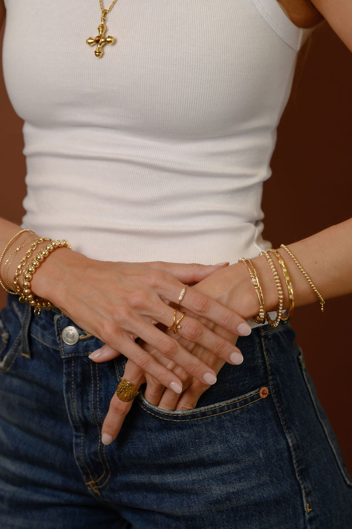 The gold North Star ring by Beads by Tara pictured on a white background