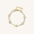 Close up of a gold bracelet with star beads covered in stones