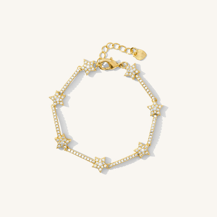 Close up of a gold bracelet with star beads covered in stones