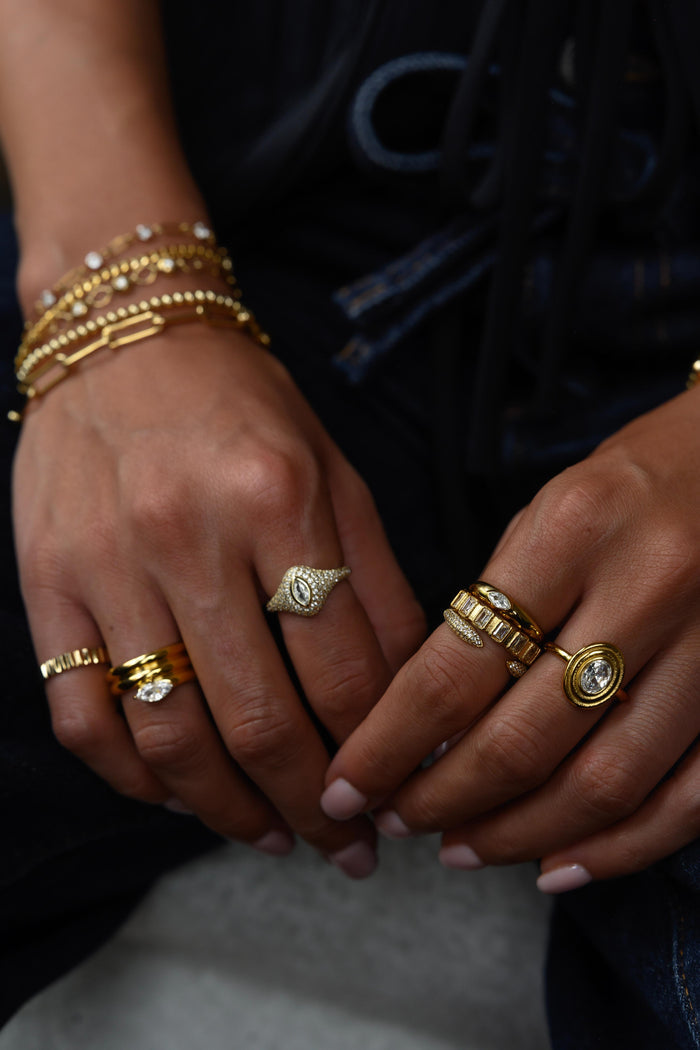 The Odette ring showing its smooth gold band and oval bezel setting