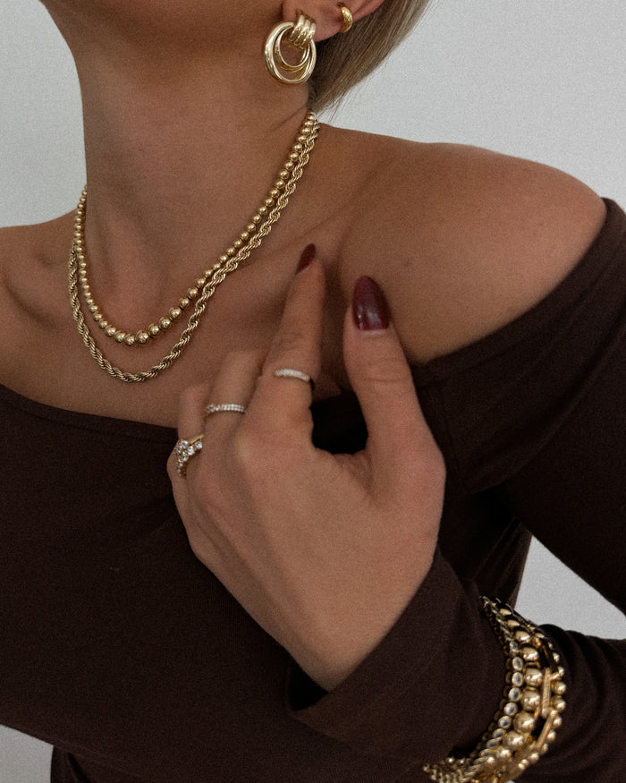 Model wearing the gold Ombre bead necklace in a campaign shot