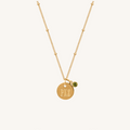 Ophelia birthstone necklace with an engraved circular pendant on a dotted chain