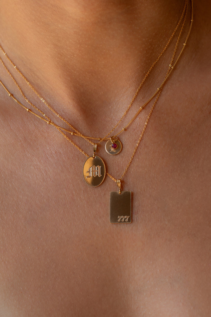 Round engraved pendant and birthstone drop on the Ophelia necklace