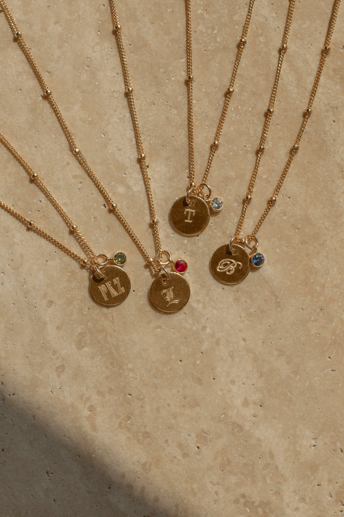 Ophelia necklace with a dotted gold chain and a colored birthstone charm