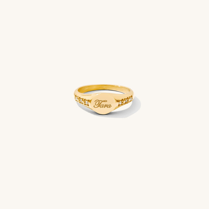 The Oval signet ring with CZ stones framing an engravable oval plate