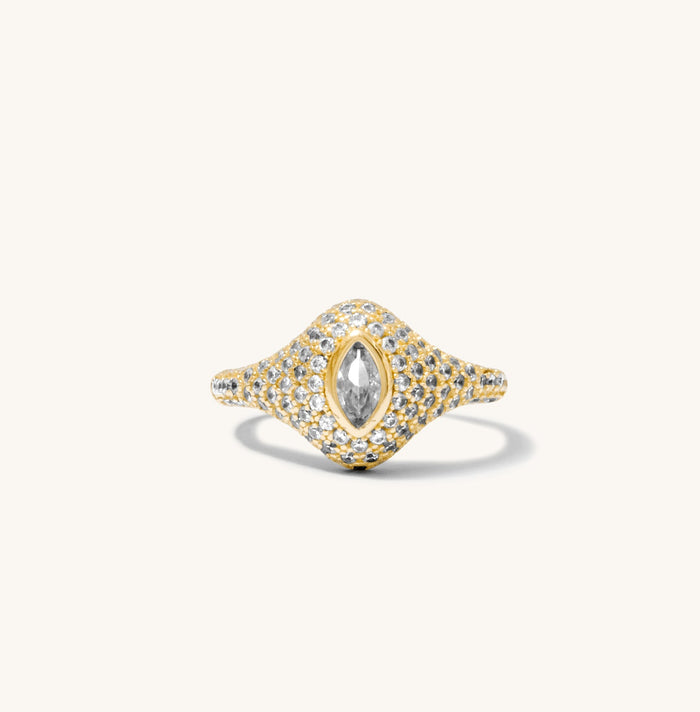 Close up of the gold pave signet ring shown on a white background