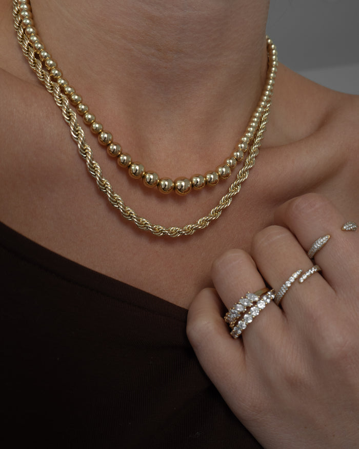 Campaign portrait of a model wearing the gold Pavé Wrap ring