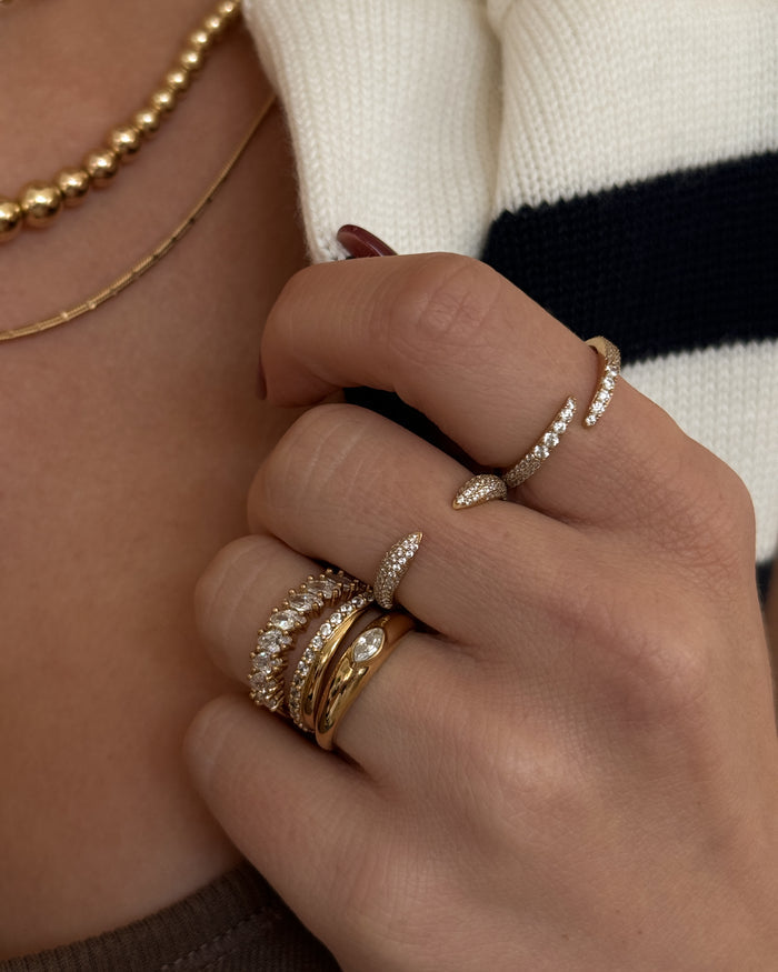 A campaign shot of a model wearing the gold Pavé Wrap ring by Beads by Tara