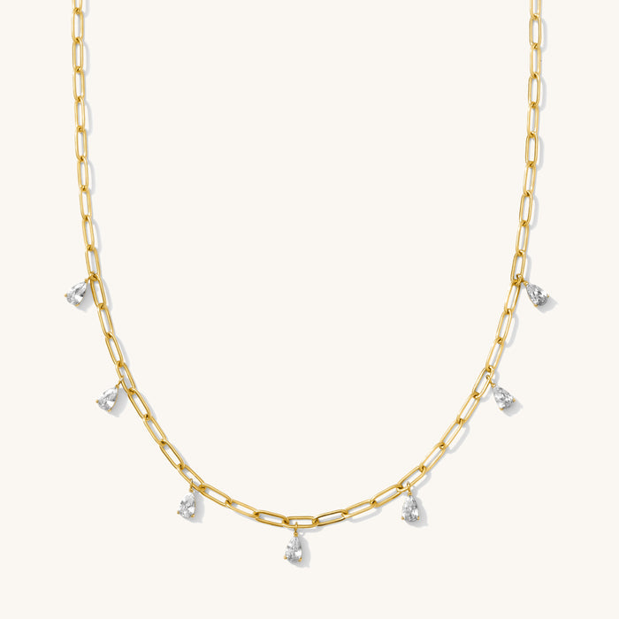 Close up of the gold Pear Drop necklace on a white background