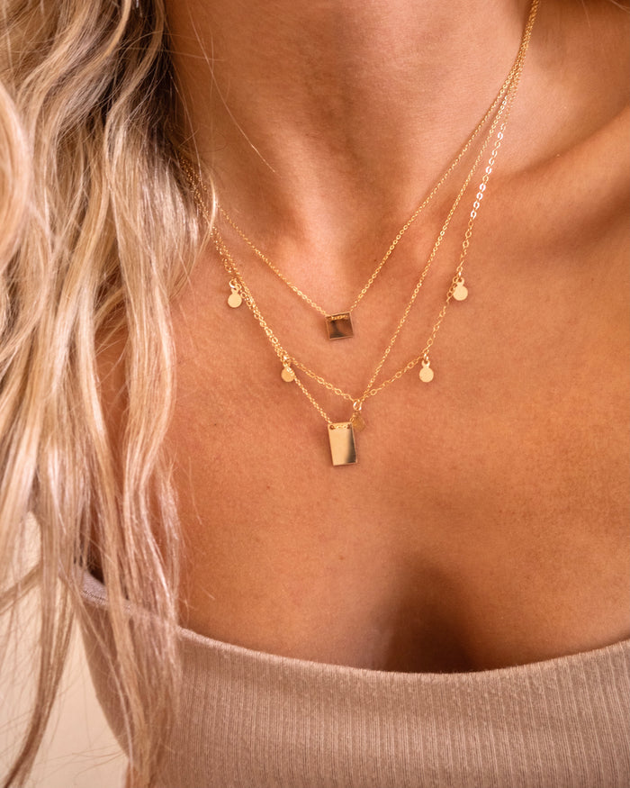 Close up of a neckline wearing the gold-filled Peyton necklace