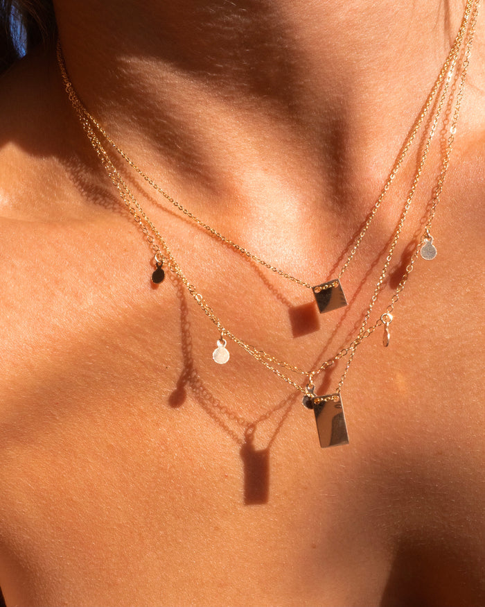 Close up of a neckline wearing the Peyton necklace in 14k gold fill