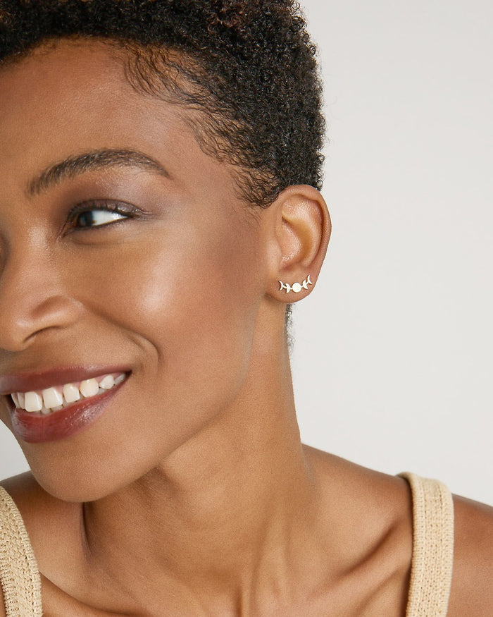 Model wearing Phases Earring Climbers in 14k gold finish