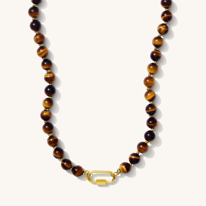 Close up of the Porto Desert Sun necklace in tiger's eye beads on a white background