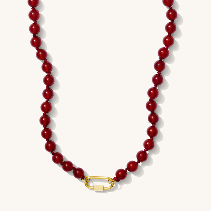 Close up of the Porto necklace in pomegranate red beads on a white background