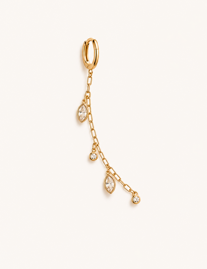 Gold earring with chain and teardrop-shaped gemstones on a white background