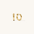Close up of gold hoop earrings on a white background