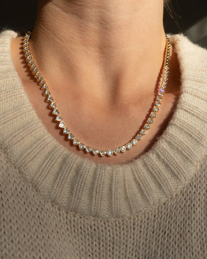 Model wearing the gold Queen of Hearts bezel tennis necklace