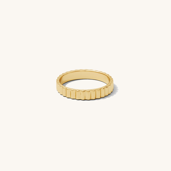Detail view of the gold Raeé fluted ring on a white background