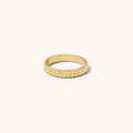 Detail view of the gold Raeé fluted ring on a white background