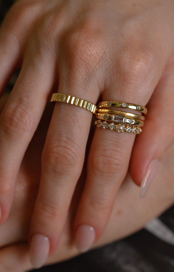 Studio close up of the gold Raeé fluted ring on a white background
