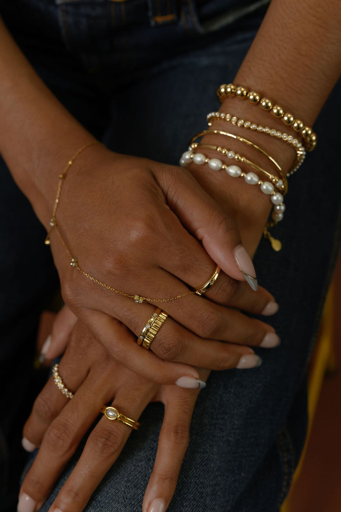 Close up of the gold Raeé fluted ring by Beads by Tara on a white background