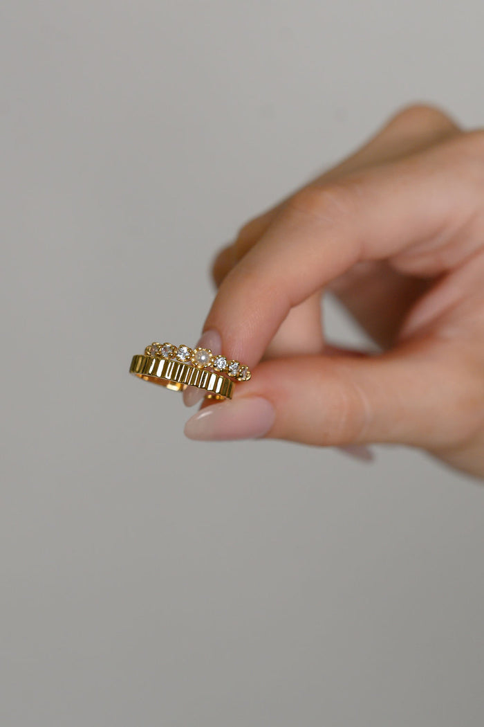 A closer look at the gold Raeé fluted ring on a white background