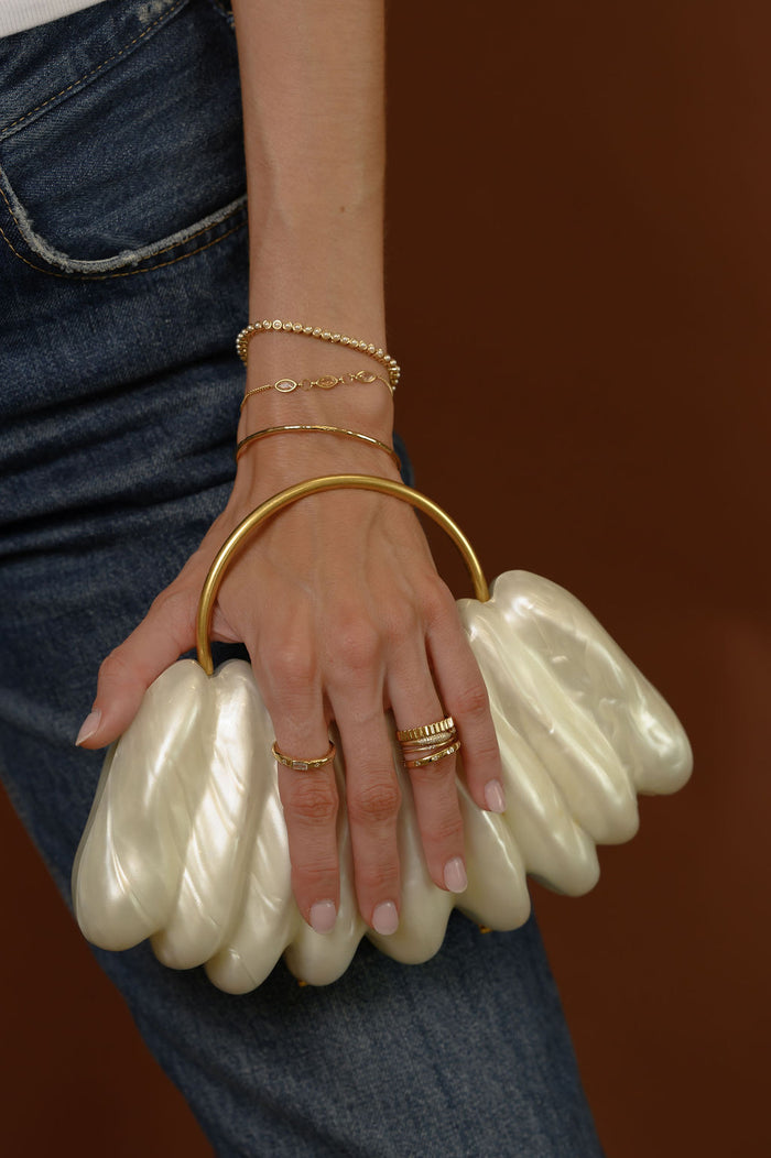 Product view of the gold Raeé fluted ring on a white background