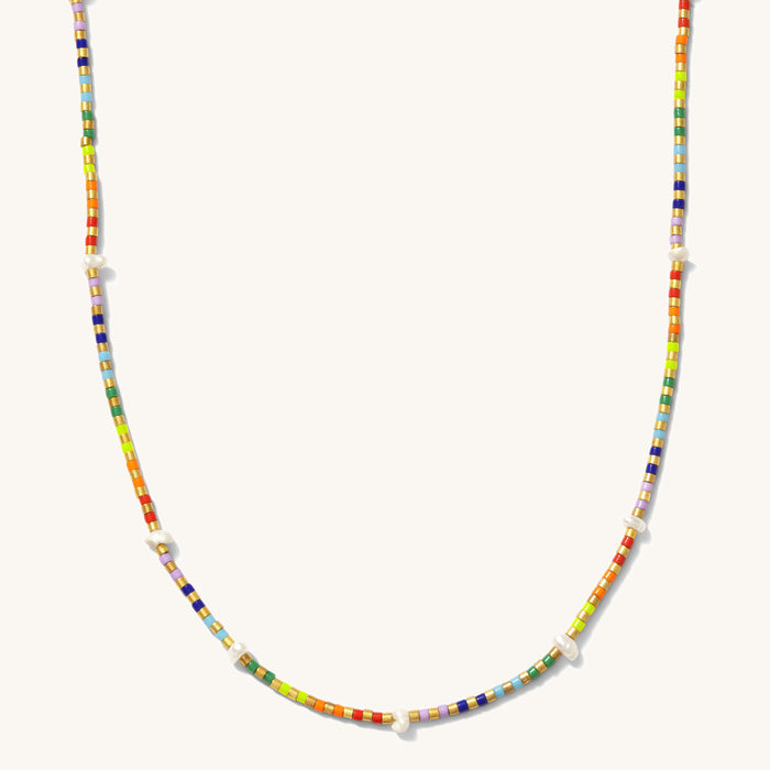 Close up of the gold Rainbow Pearl necklace on a white background