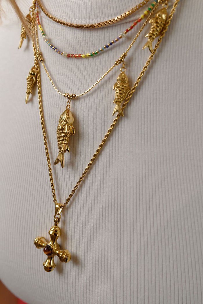 Studio close up of the gold Rainbow Pearl necklace on a white background