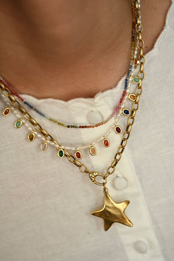 Necklace with star pendant and colorful beads on a white background