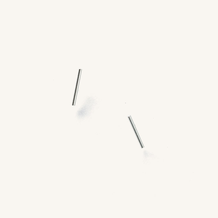 Close up of silver bar studs on a white background