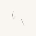 Close up of silver bar studs on a white background