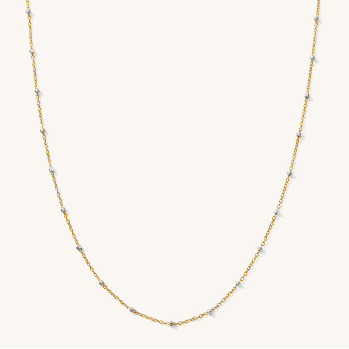 Close up of the two-tone Riley bead necklace on a white background